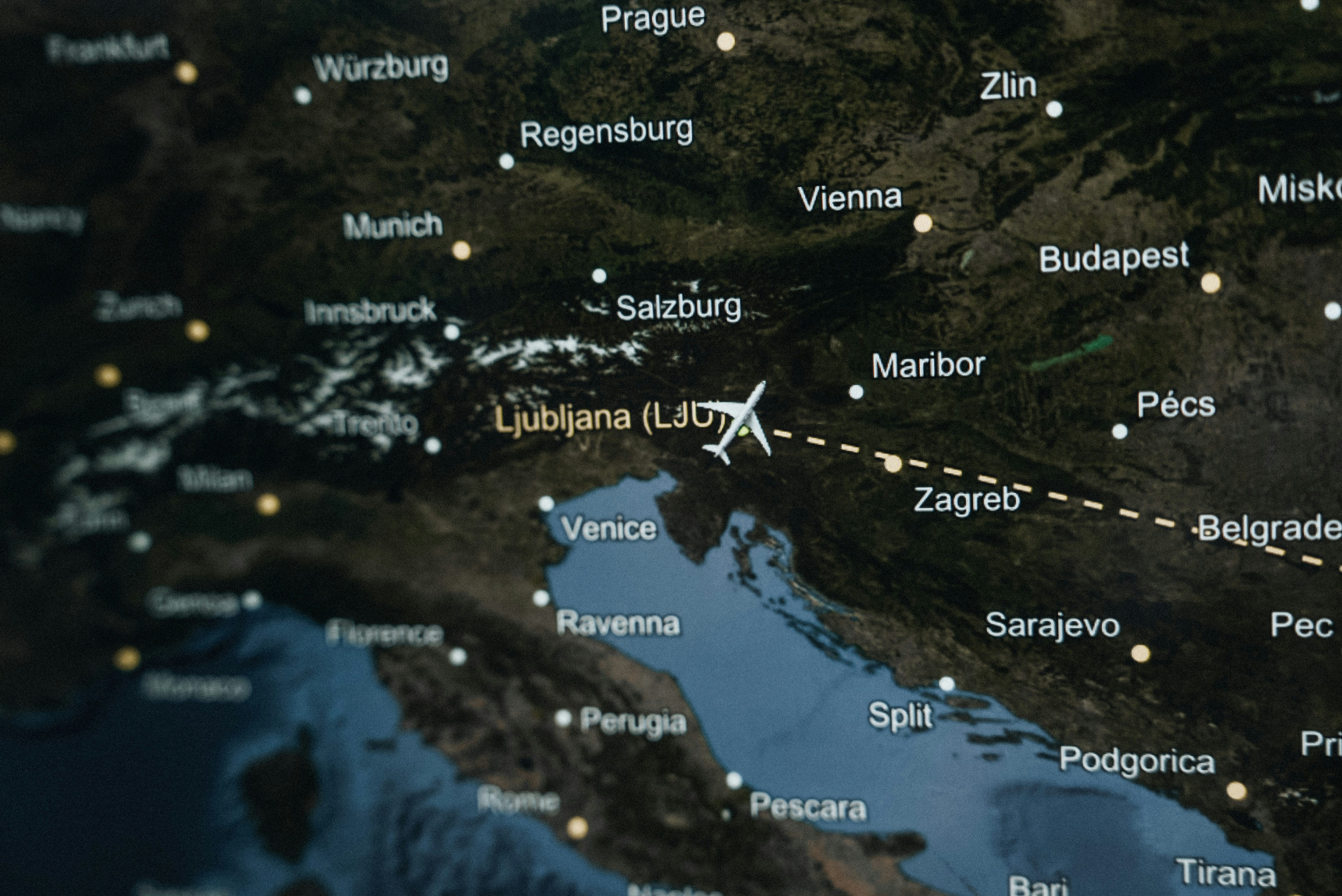 A map of the world with a plane flying over it